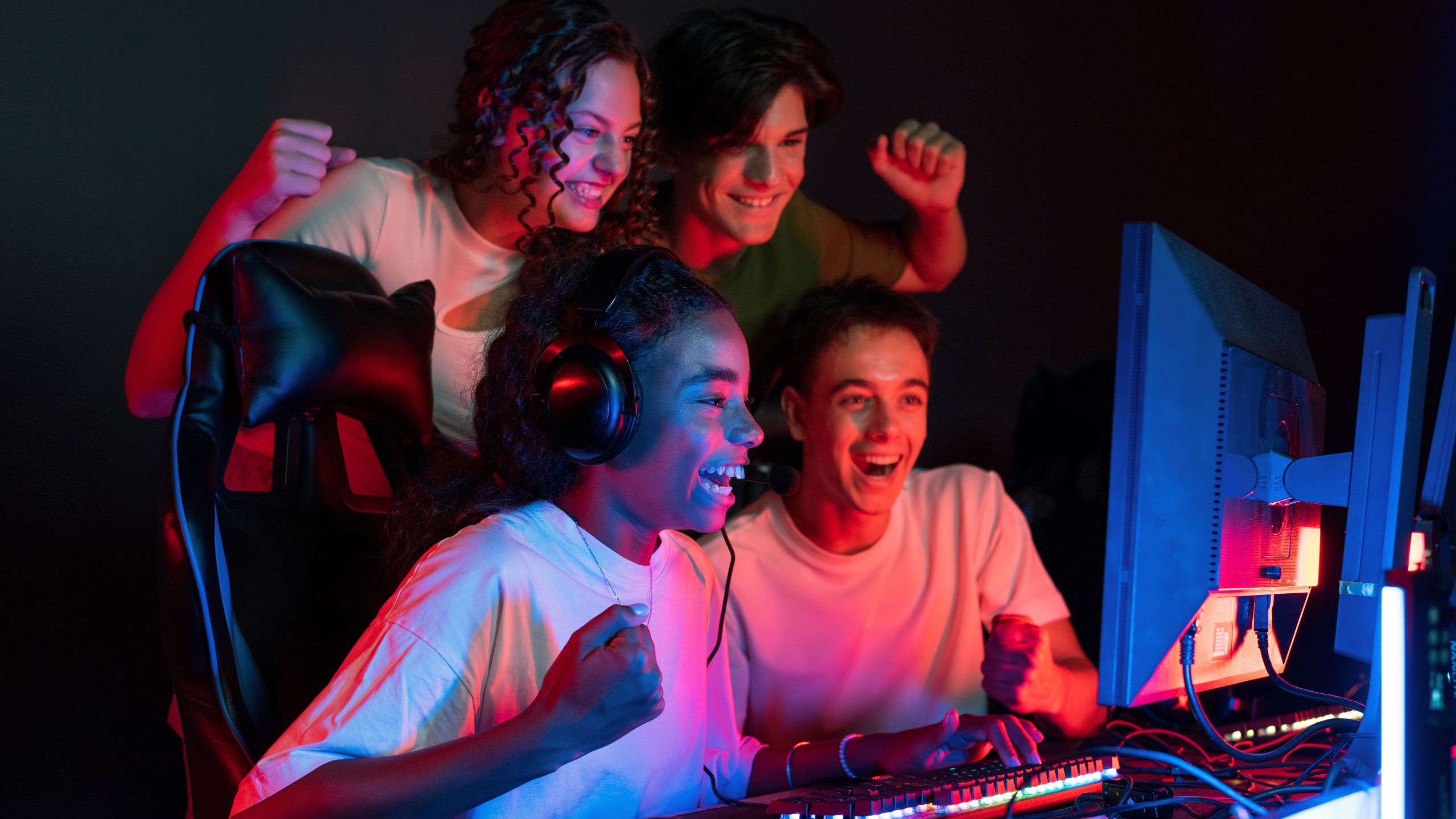 group-multiracial-teens-playing-video-games-video-game-club-with-blue-red-illumination-excited-because-victory-11zon